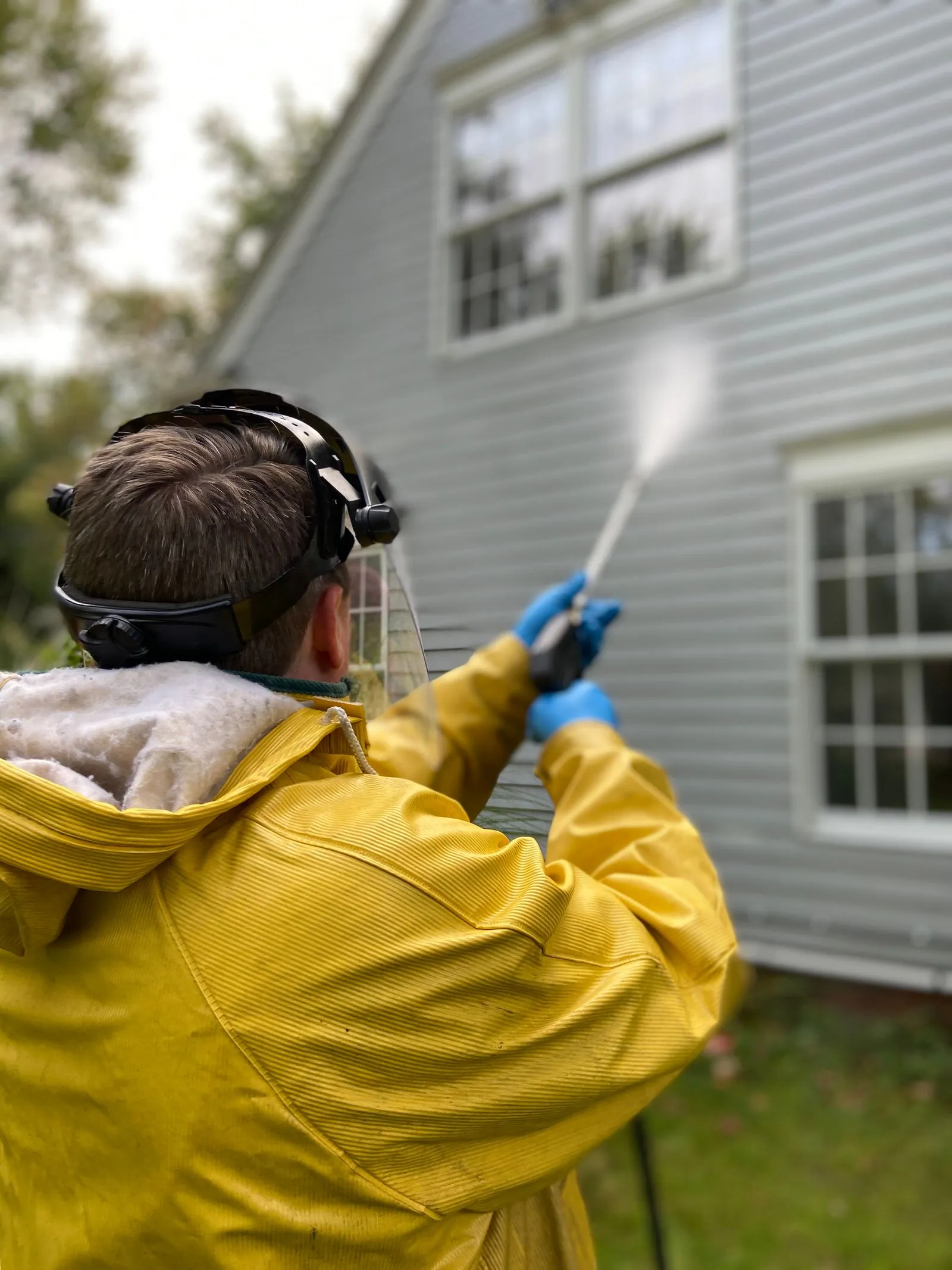 Technician pressure washing house siding in Jacksonville